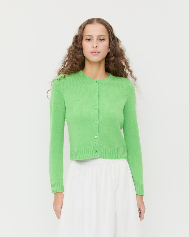 Tucker Cardigan in green cashmere and Delaney Skirt in white cotton.