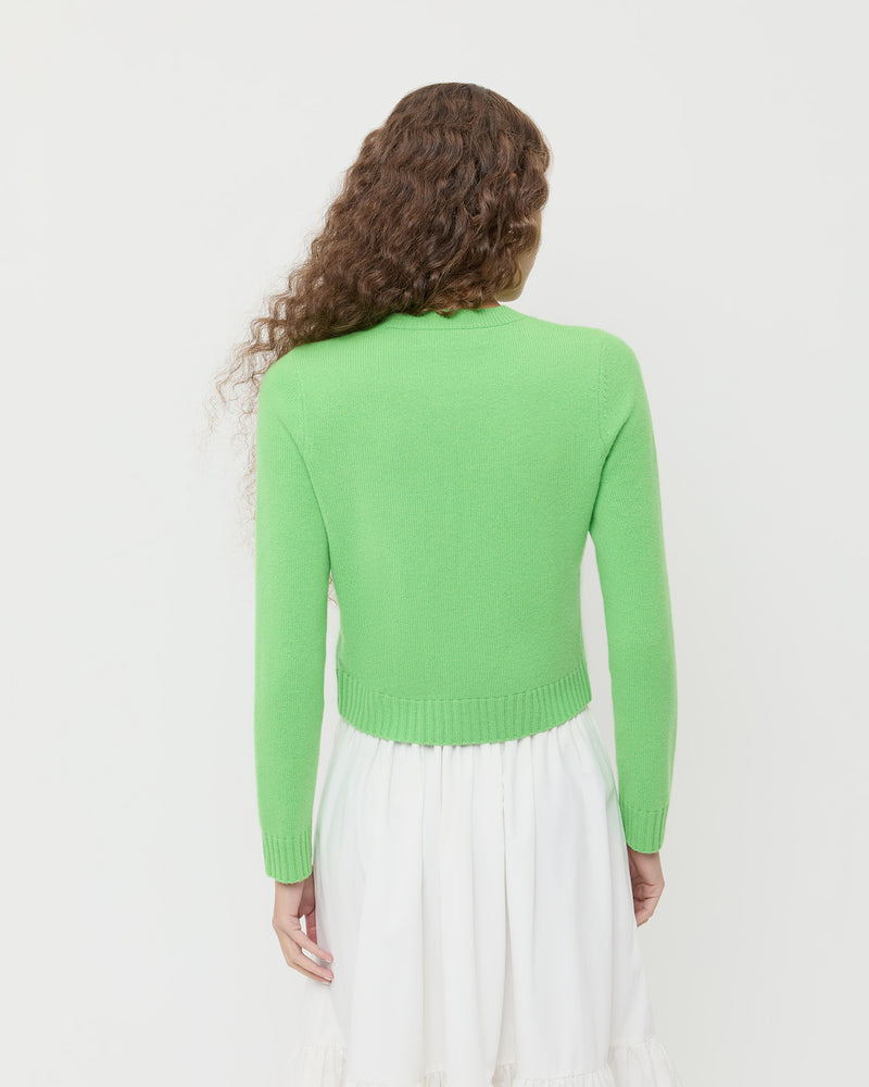 Tucker Cardigan in green cashmere and Delaney Skirt in white cotton.