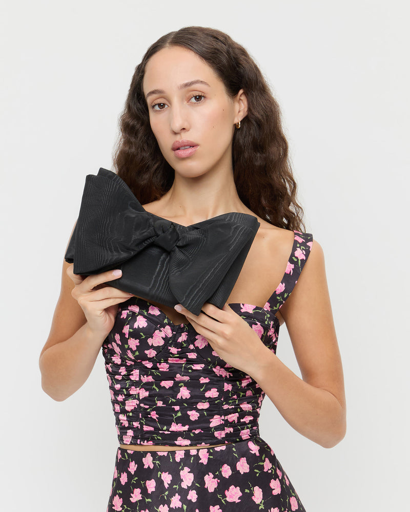 Valerie Black Moiré Bow Clutch in black moiré, Cresta Top in black rosette textured fabric, and Mandy Skirt in black rosette textured fabric.