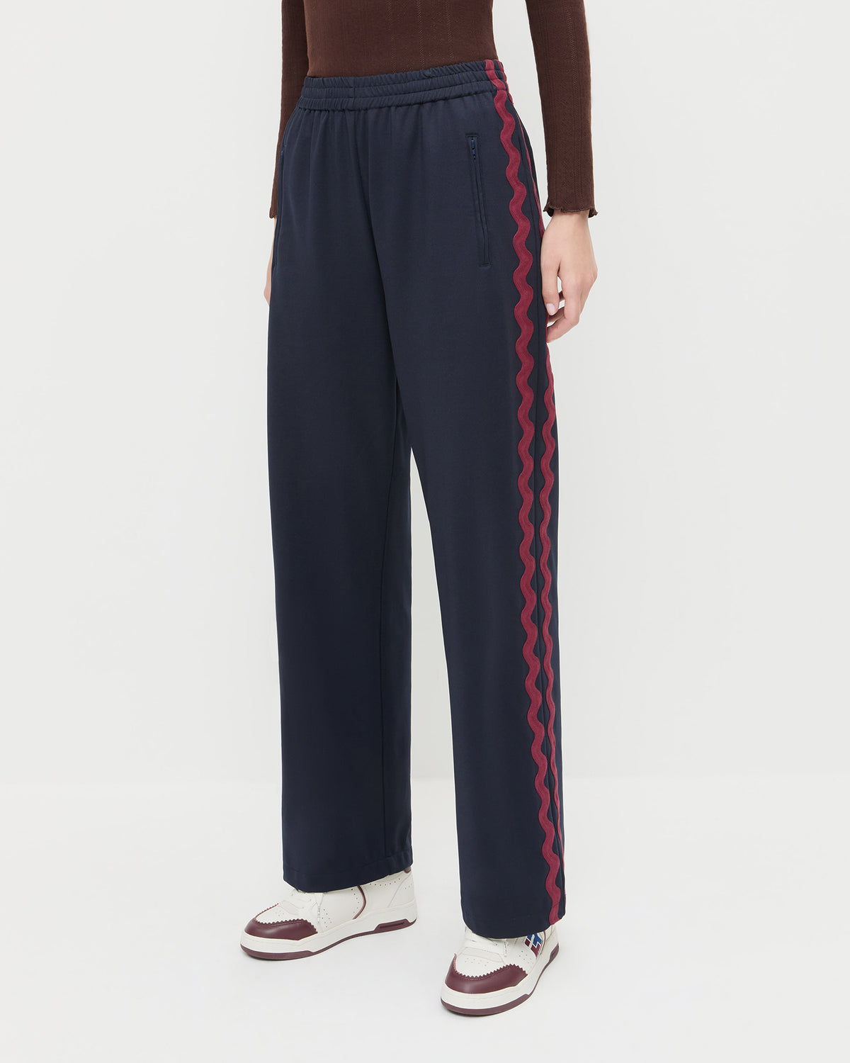 Venus Track Pant in navy nylon, Lolo Pointelle Long-Sleeve in espresso brown cotton, and Topspin Cream/Maroon Court Sneaker.