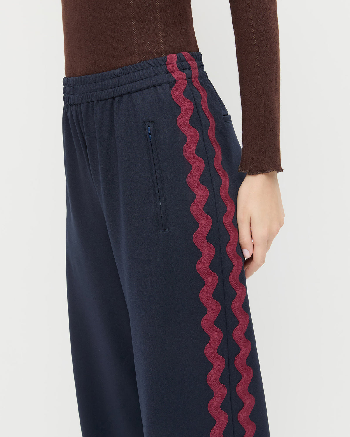 Venus Track Pant in navy nylon and Lolo Pointelle Long-Sleeve in espresso brown cotton.