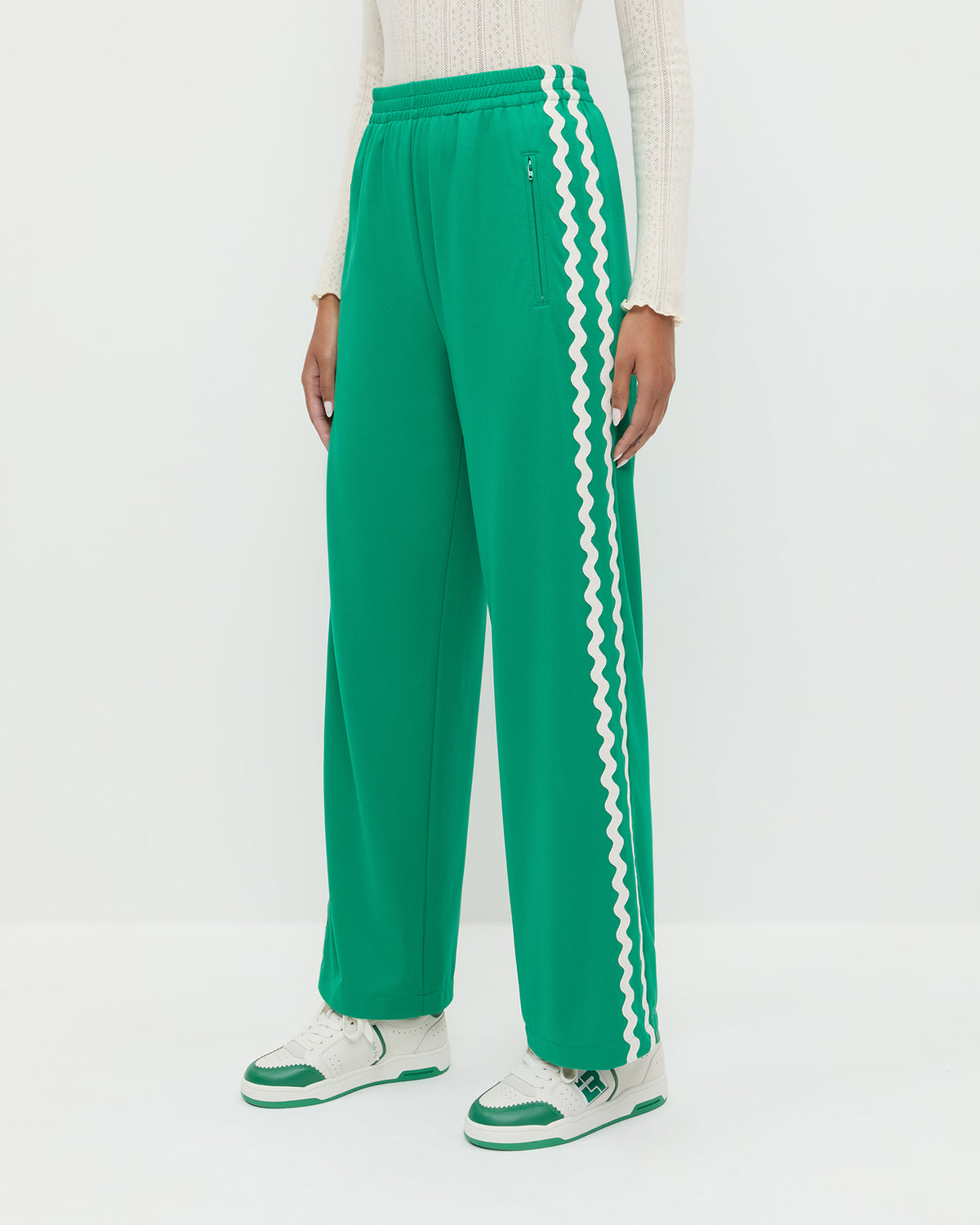 Venus Track Pant in green nylon, Lolo Pointelle Long-Sleeve Top in cream pointelle, and Topspin Cream/Green Court Sneaker.