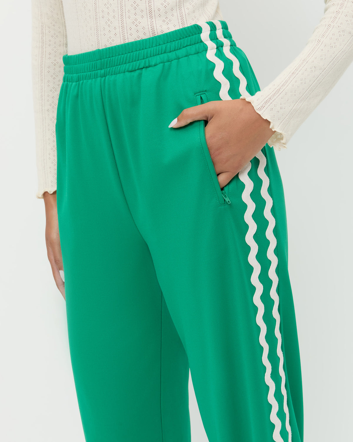 Venus Track Pant in green nylon, Lolo Pointelle Long-Sleeve Top in cream pointelle.