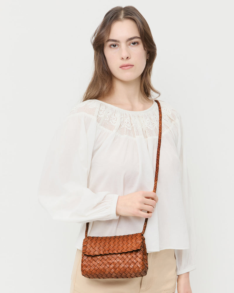 Vinnie Timber Woven Leather Crossbody in brown timber woven leather, Hattie Top in white cotton, and Demi Embroidered Pant in tan cotton.