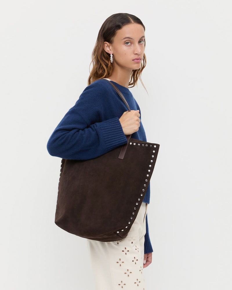 Walker Brown/Silver Suede Tote in brown suede and silver studs, Lana Cashmere Sweater in navy, and Dem Embroidered Pant in natural.