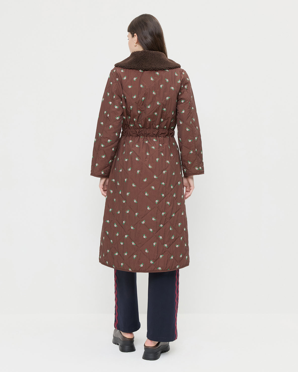 Wyatt Quilted Coat in brown nylon with flower embroidery, Venus Track Pant in navy nylon, and Gemma Brown Leather Lug Mule.