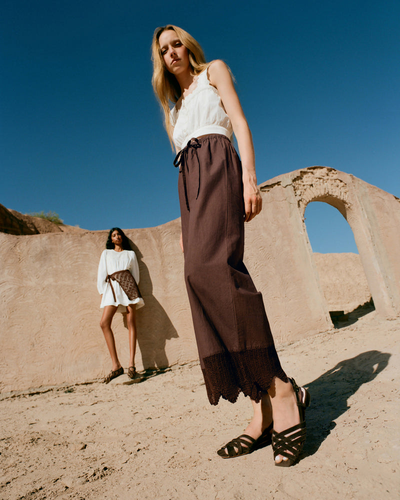 Amani Pant in dark brown cotton, Runa Top in white cotton, and Shelly Brown Suede Flat Sandal.