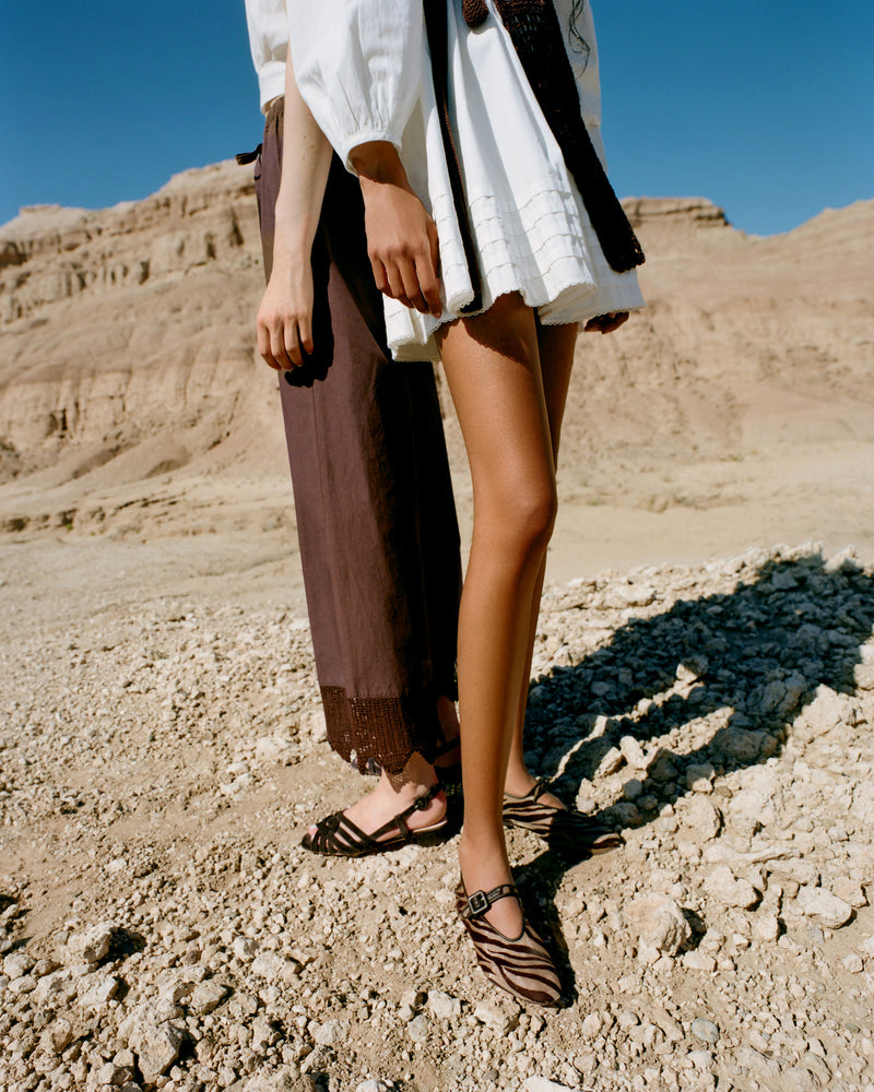 Amani Pant in dark brown cotton, Runa Top in white cotton, and Shelly Brown Suede Flat Sandal.