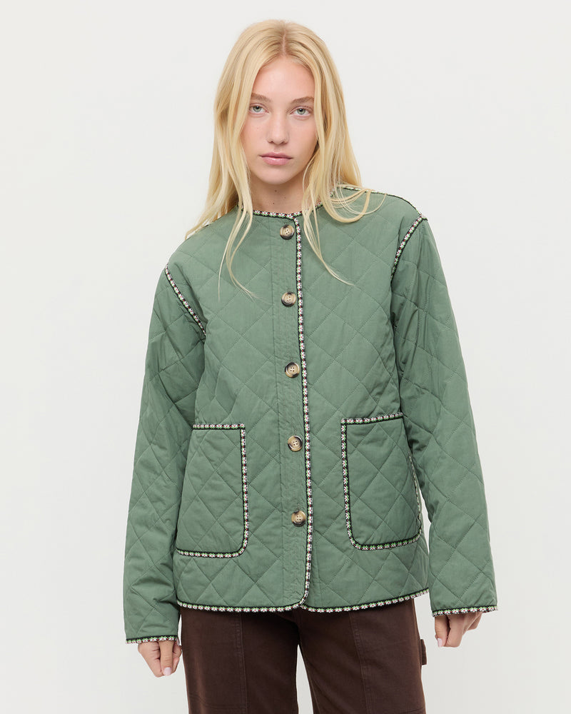 Carolina Quilted Coat in sage green quilted nylon and Molly Workwear Jean in dark brown denim.