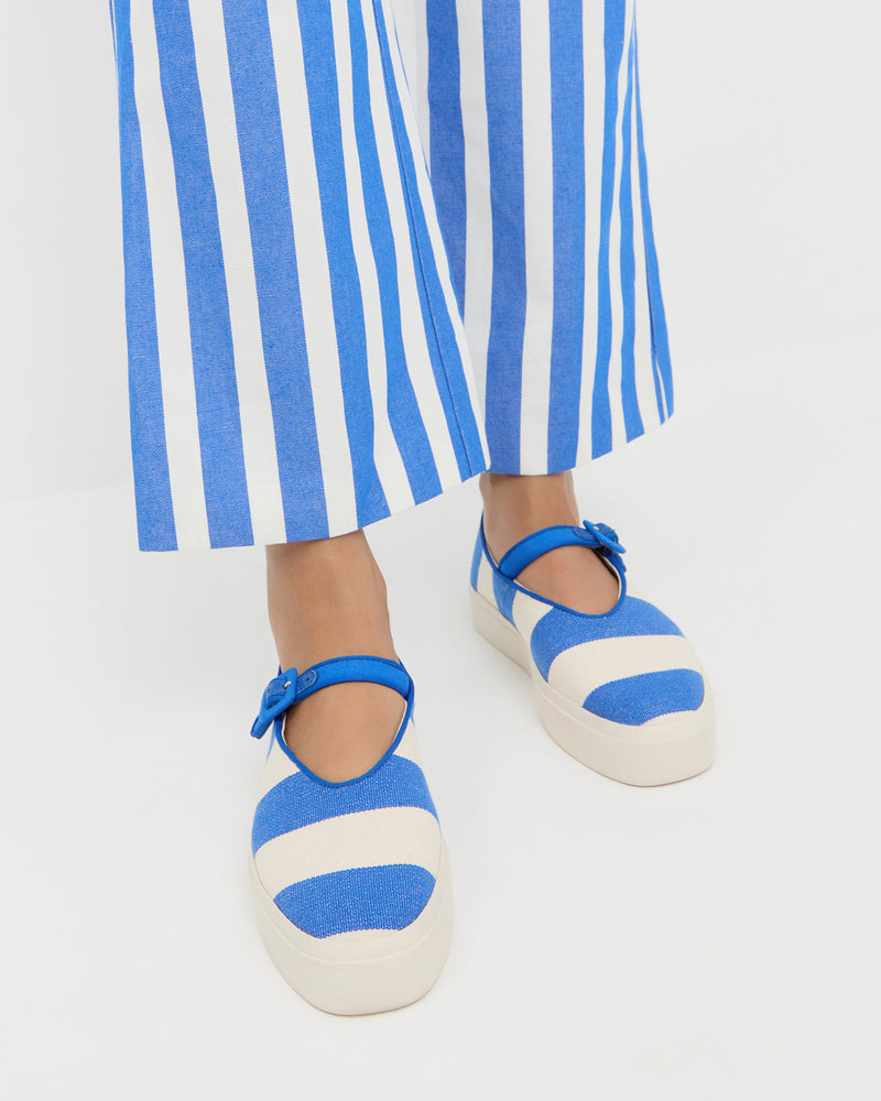 Cooper Blue Striped Mary Jane Sneaker in blue and cream striped canvas and Pasha Trouser in blue and cream striped cotton-linen.