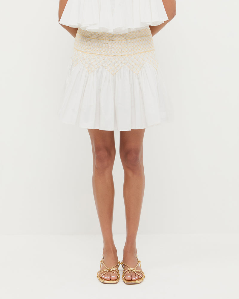 Florrie Mini Skirt in cream cotton, Nola Top in cream cotton, and Karly Gold Leather Strappy Sandal.