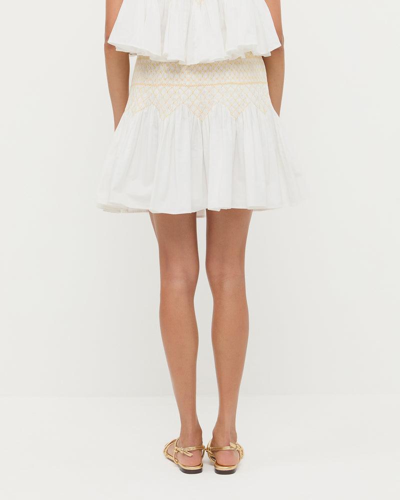 Florrie Mini Skirt in cream cotton, Nola Top in cream cotton, and Karly Gold Leather Strappy Sandal.
