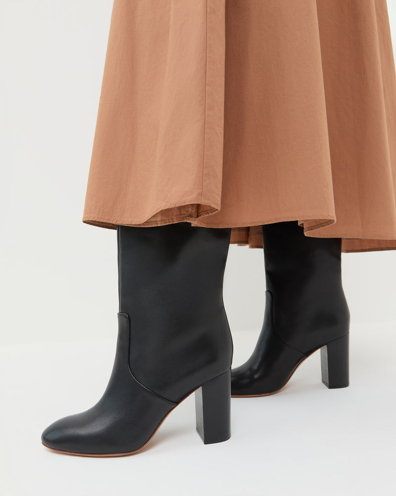 Goldy Black Wide-Calf Tall Boot in black leather and Peyton Skirt.