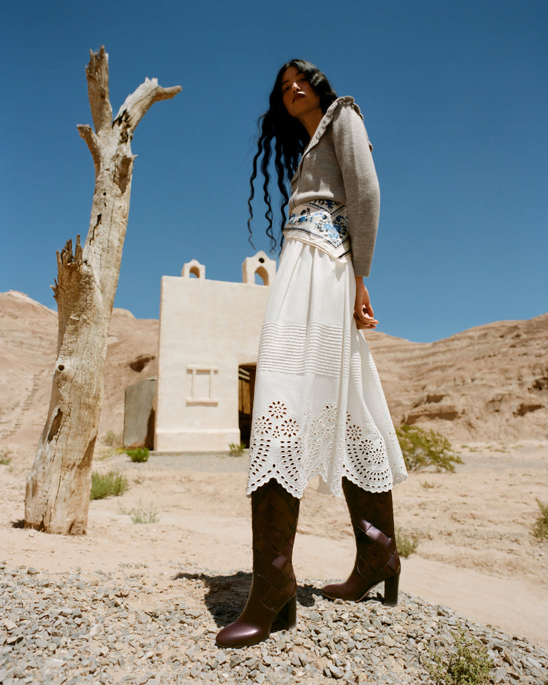 Goldy Espresso Woven Leather Tall Boot in espresso woven leather, Wynn Cardigan in grey wool, and Tinsley Skirt in white cotton.