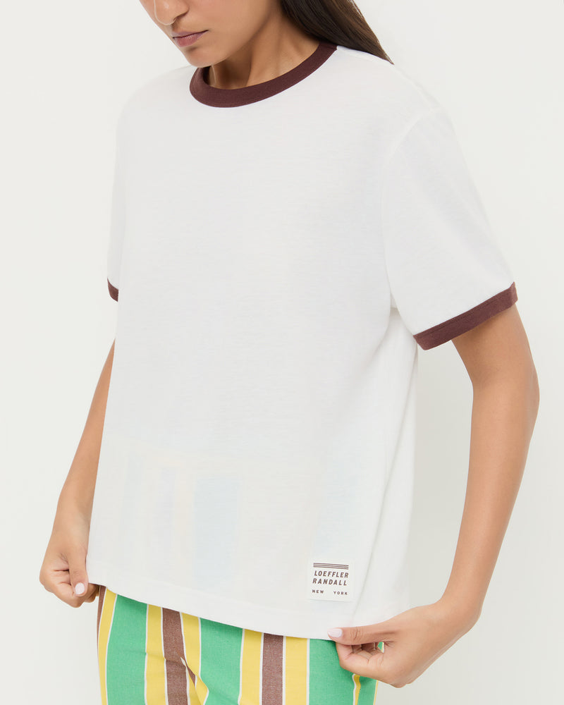 Harly Tee in white cotton with brown accents and Pasha Trouser in green/yellow striped cotton-linen.