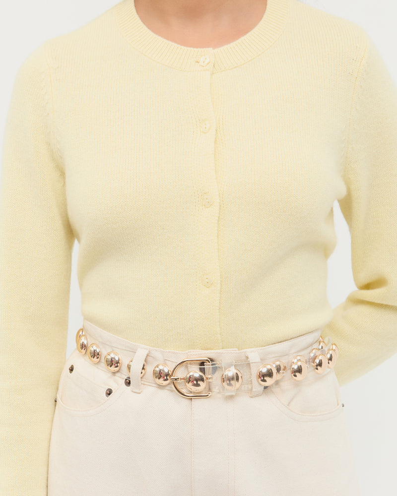 Issa Clear/Champagne Studded Belt in clear plastic with champagne stud accents, Tucker Cashmere Cardigan in butter yellow cashmere, and Winona Denim Pant in natural denim.