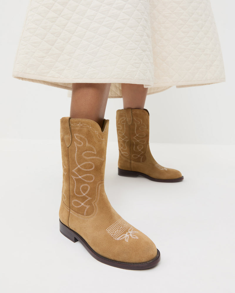 Jett Sand Suede Calf Boot in sand tan suede and western inspired and Clara Quilted Skirt in cream cotton.