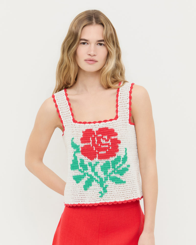 Juliette Top in white hand crocheted cotton with a flower accent and Carissa Short in red linen. 