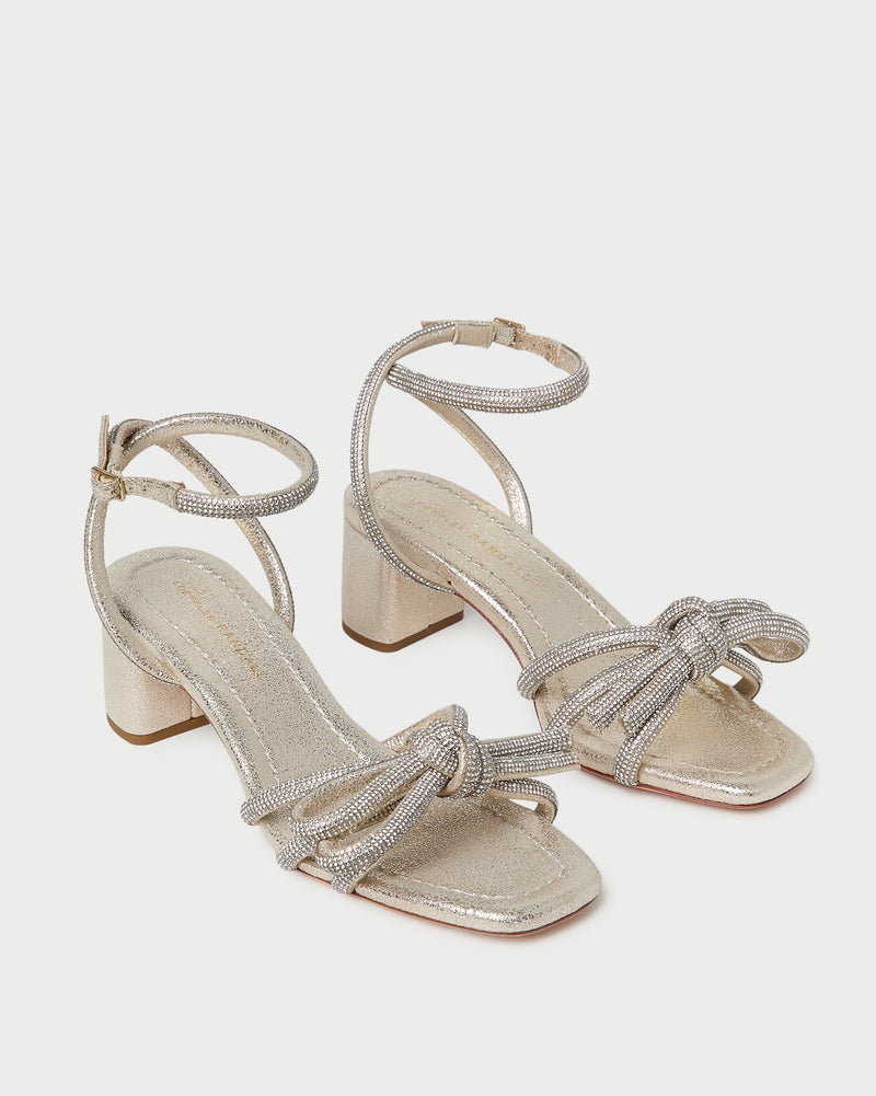 Mikel Cappuccino Bow Mid-Heel Sandal in light champagne sparkle suede