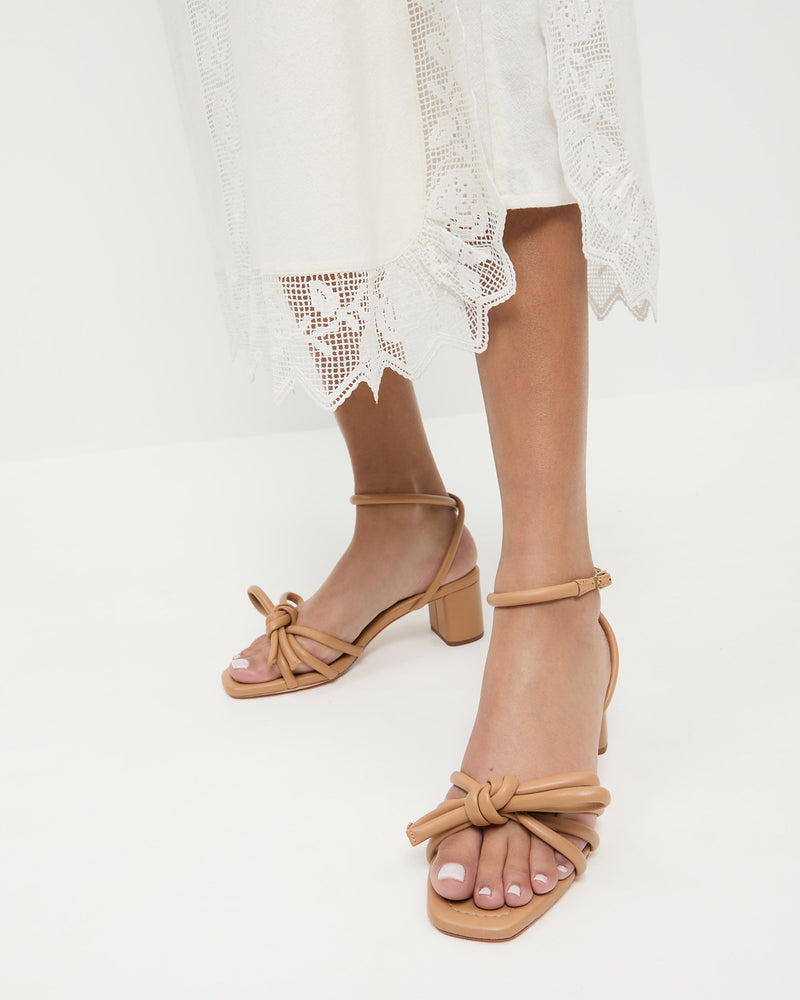 Mikel Dune Bow Mid-Heel Sandal in beige tan leather and Poppy Dress in white cotton.