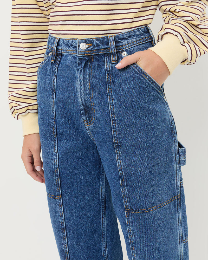 Molly Workwear Jean in medium wash blue denim, and Scout Long-Sleeve Top in butter yellow.