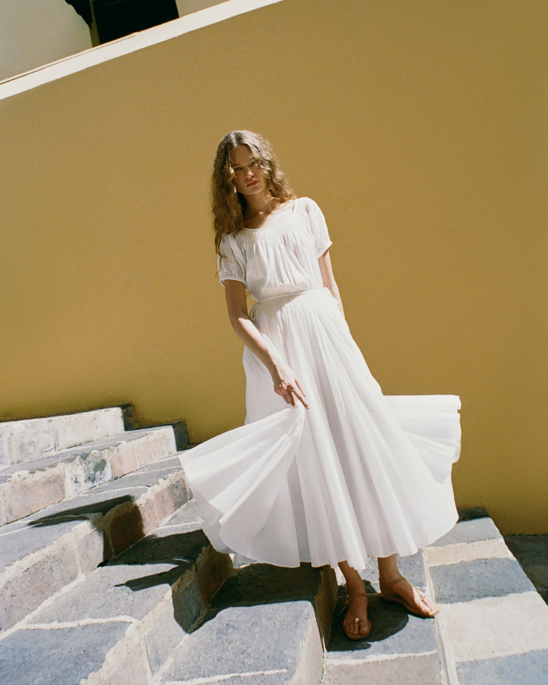 Nadya Dress in cream cotton and Lara Dune Leather Flat Sandal.