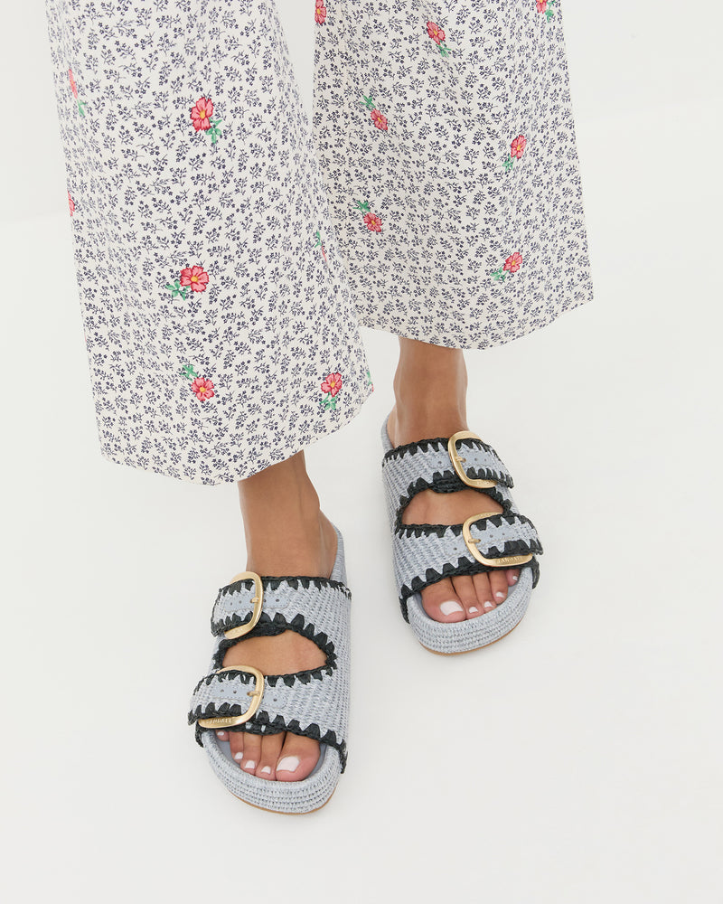 Nico Blue Two-Band Sandal in blue woven fabric and Pasha Trouser in white floral cotton-linen.