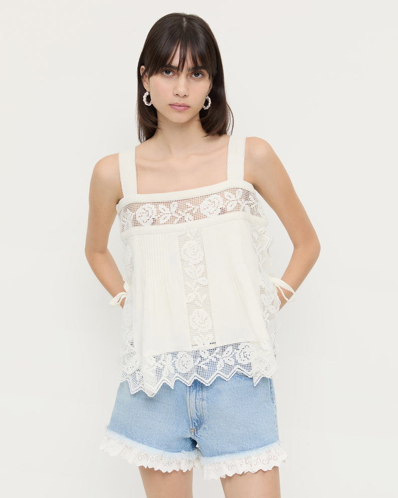 Pia Top in white cotton and Kay Lace-Trimmed Denim Shorts in light blue denim with white lace trim.