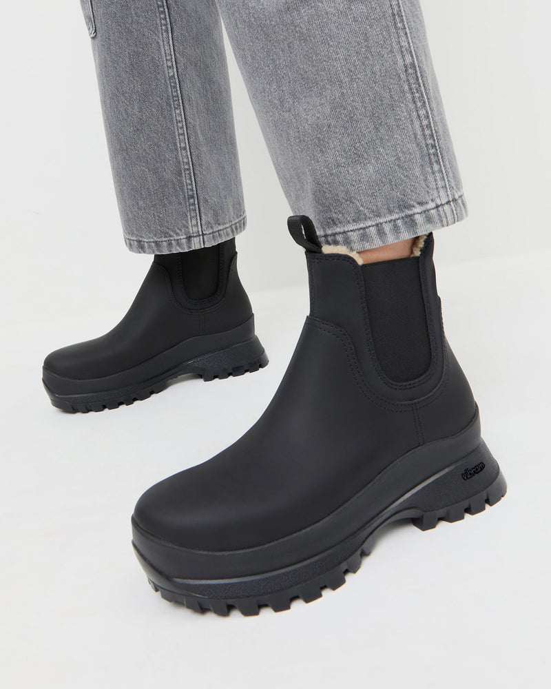Tara Black Shearling-Lined Boot in black leather.