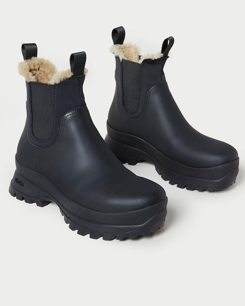 Tara Black Shearling-Lined Boot in black leather.