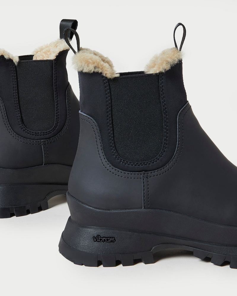 Tara Black Shearling-Lined Boot in black leather.