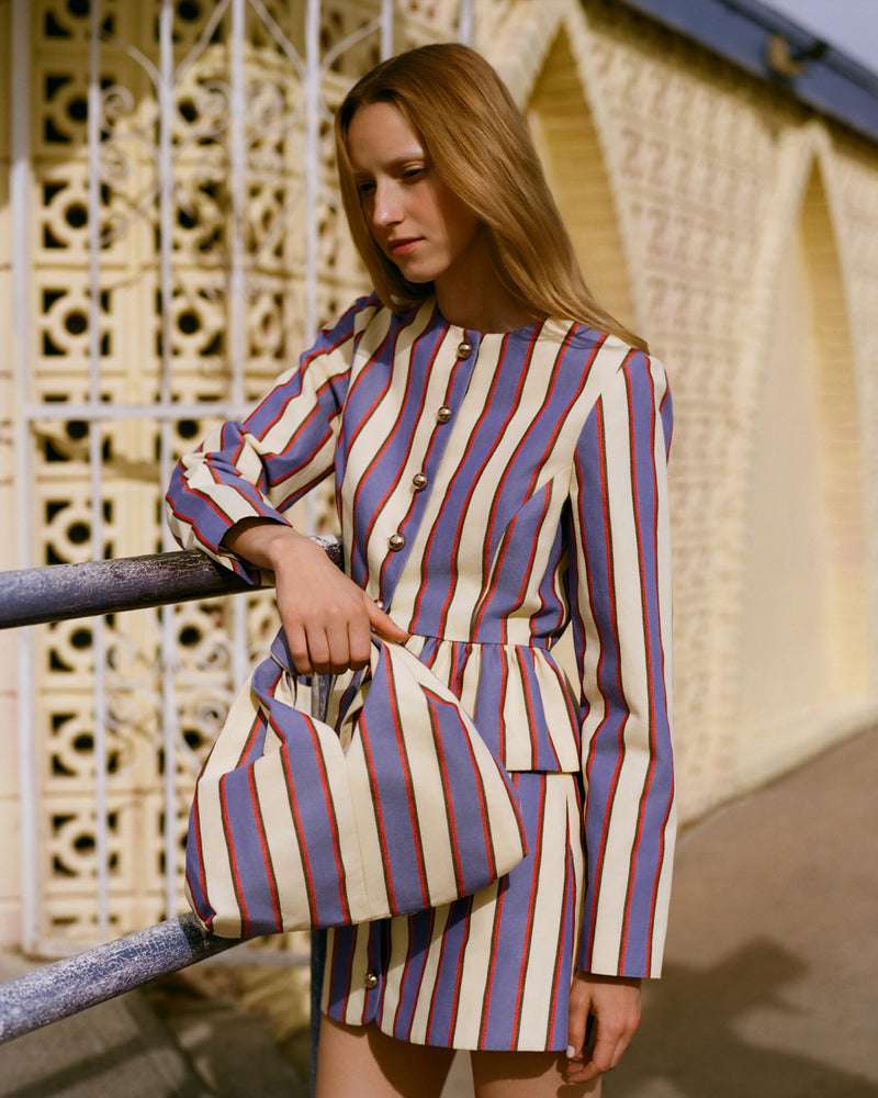 Sable Jacket in jewel and butter striped cotton-linen fabric, Vita Skirt in jewel and butter striped cotton-linen fabric, and Helga Jewel/Butter Knot Clutch.