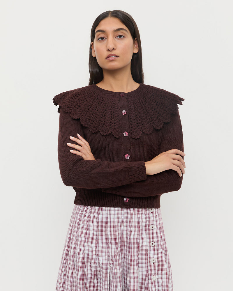 Wynn Cardigan in dark brown wool, and Emlyn Midi Skirt in cream, maroon, and lilac plaid cotton.