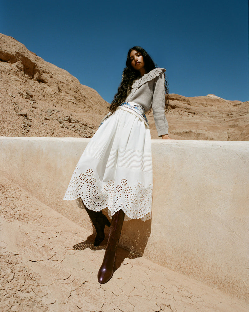 Wynn Cardigan in grey wool, Tinsley Skirt in white cotton, and Goldy Espresso Woven Leather Tall Boot.